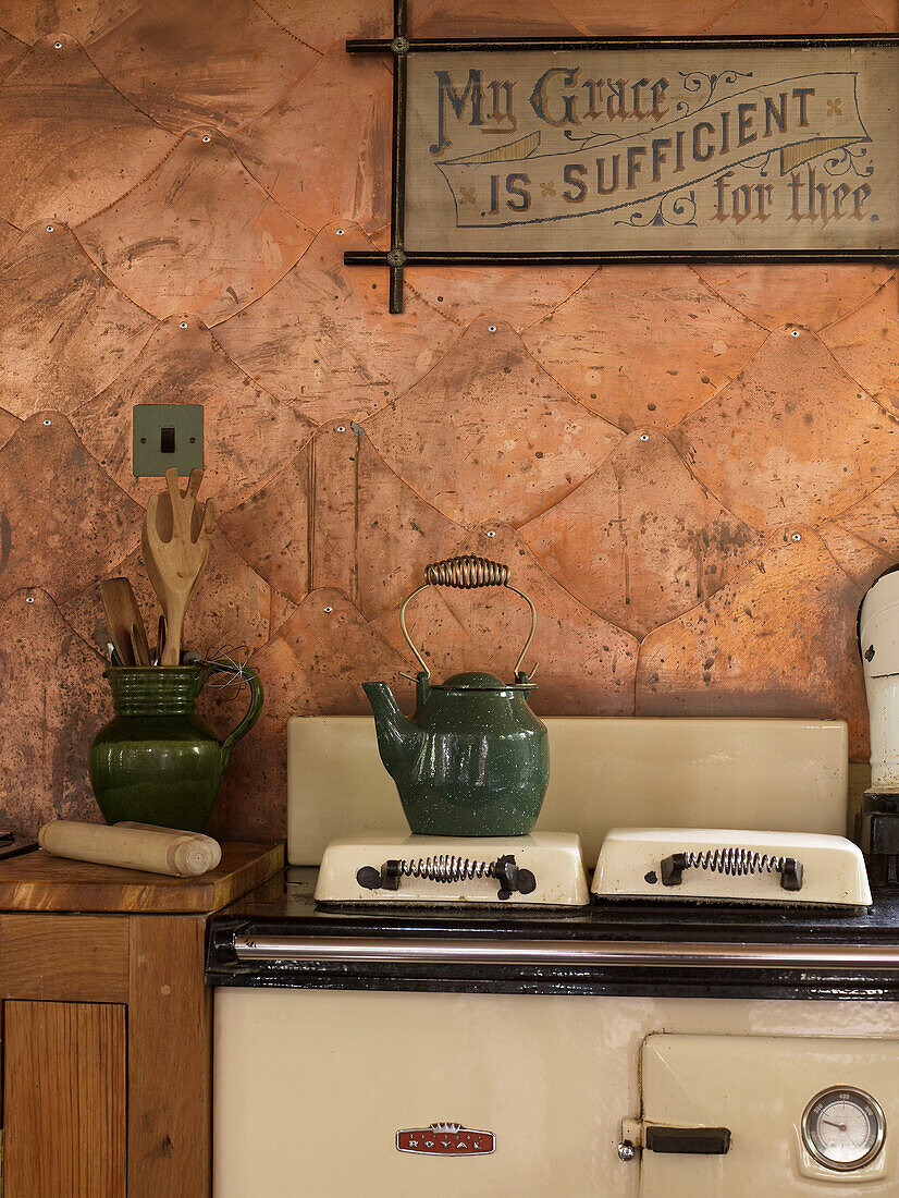 Kettle on hob of range oven in converted Shropshire chapel kitchen England, UK