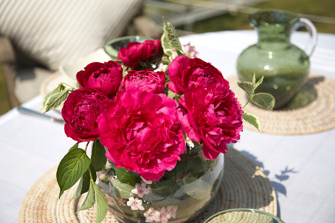 Centrepiece and jug on balcony table al fresco dining in Somerset new build rural England UK