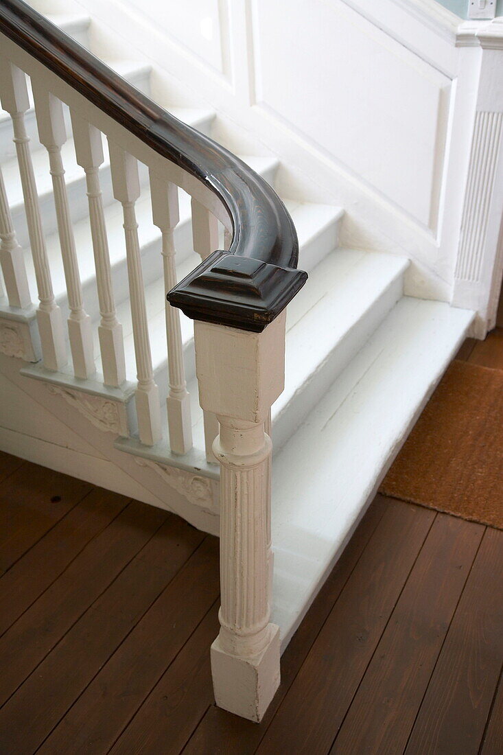 Painted staircase with polished wooden handrail in Georgian townhouse, Laughame, Wales, UK