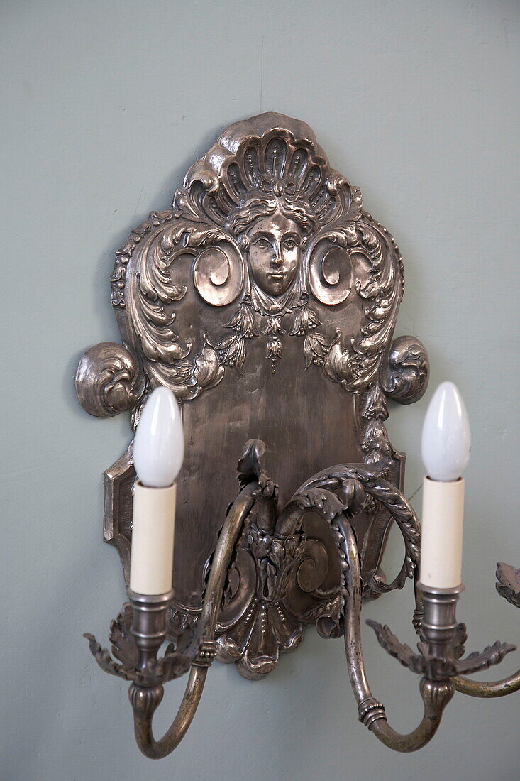 Decorative silver wall sconce in Georgian townhouse, Laughame, Wales, UK
