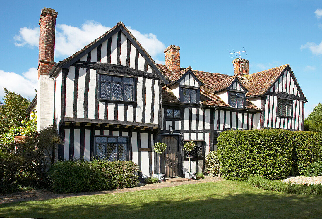 Lawned exterior of timber framed house in Suffolk, England, UK