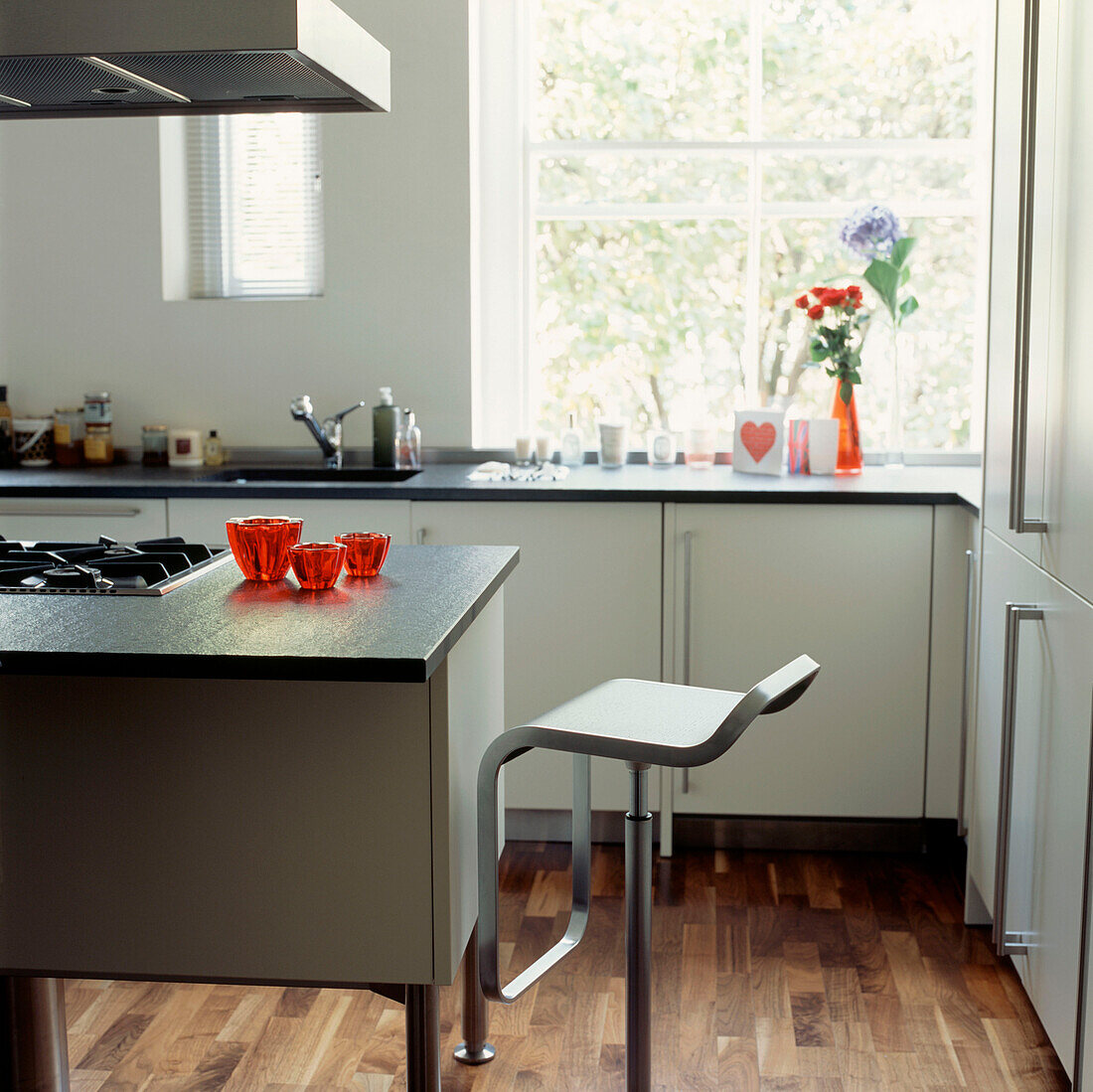 Contemporary kitchen with wooden floor and stool