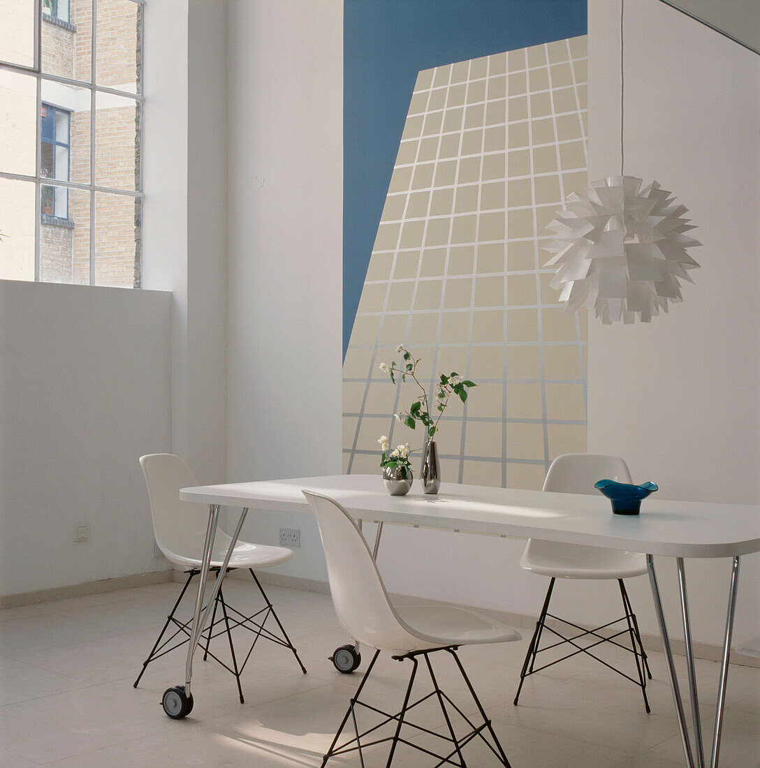 Contemporary coordinating dining room with stone floor white dining table and chairs and turquoise and white decor