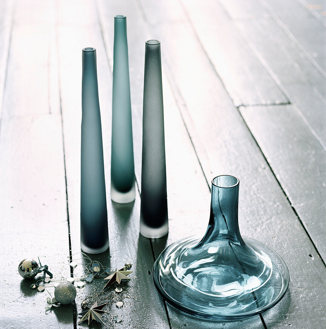 Blue and grey glass coloured vases on a painted wooden floor