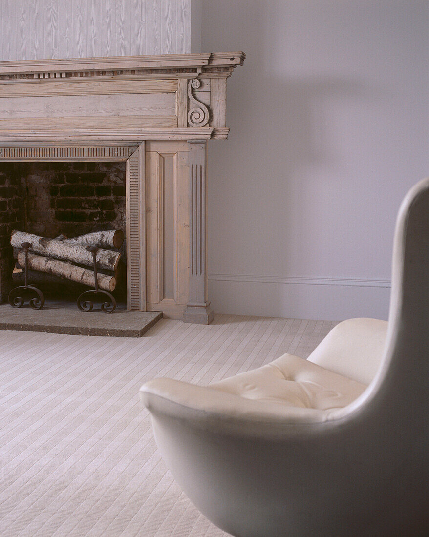 Neutral coloured carpeted living room with open fire and matching decor