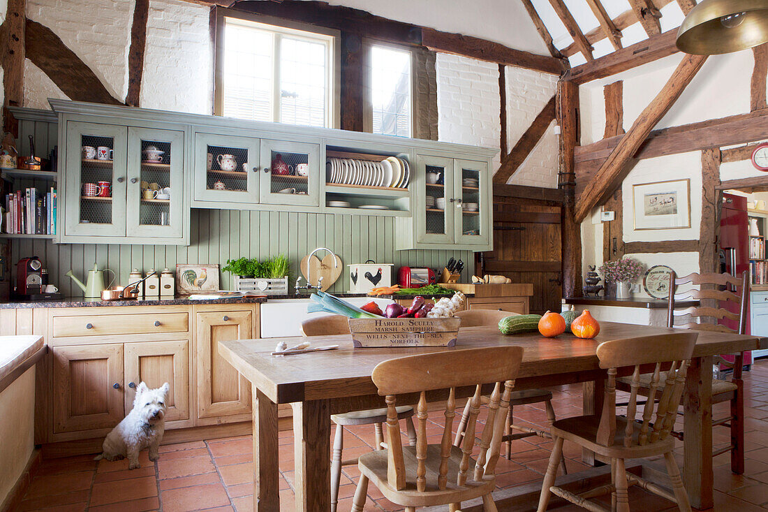 Timber framed kitchen with wooden table and chairs in Surrey barn conversion England UK
