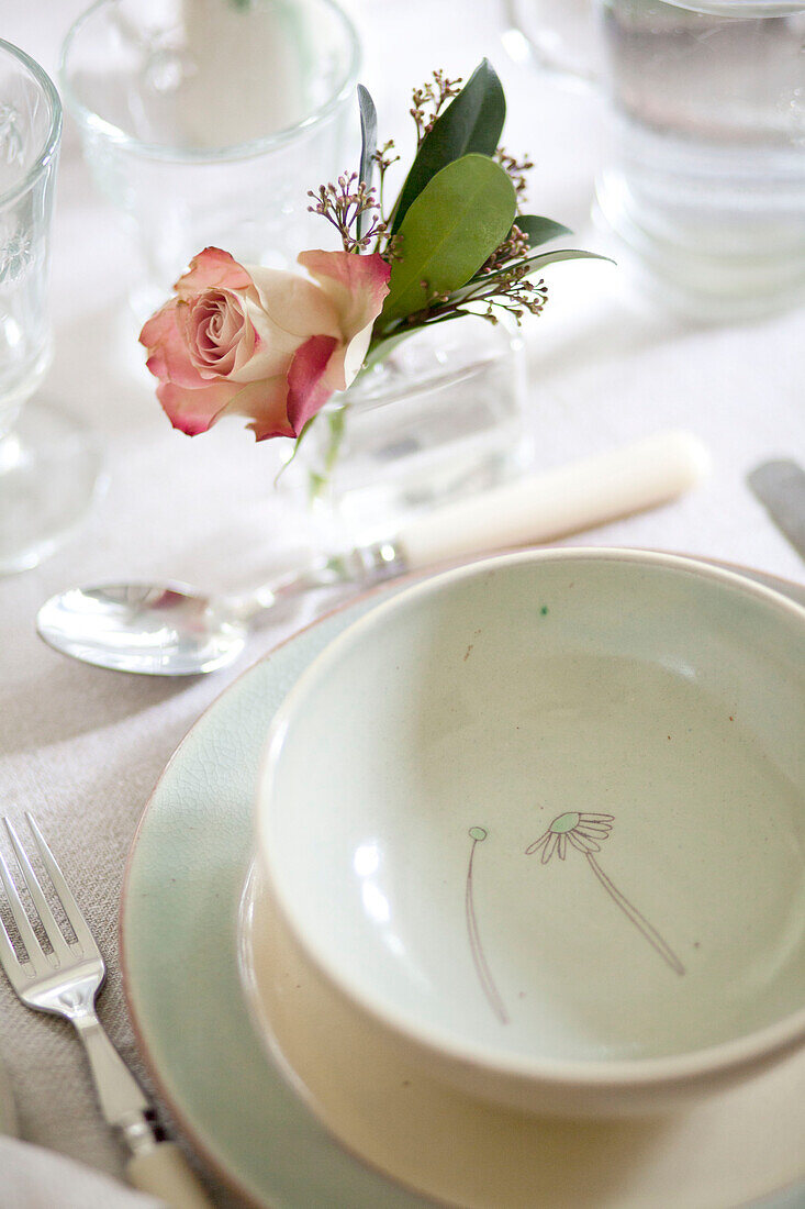 Single stem rose at place setting in Surrey cottage England UK