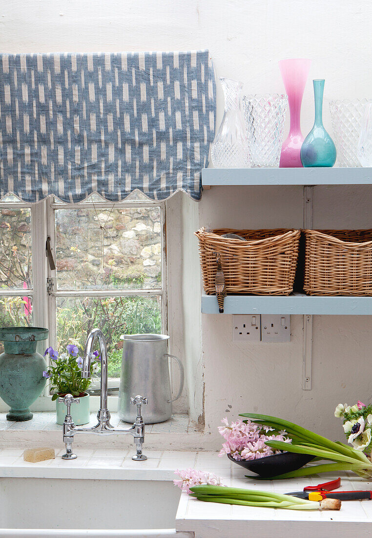 Cut flowers at kitchen sink of UK home