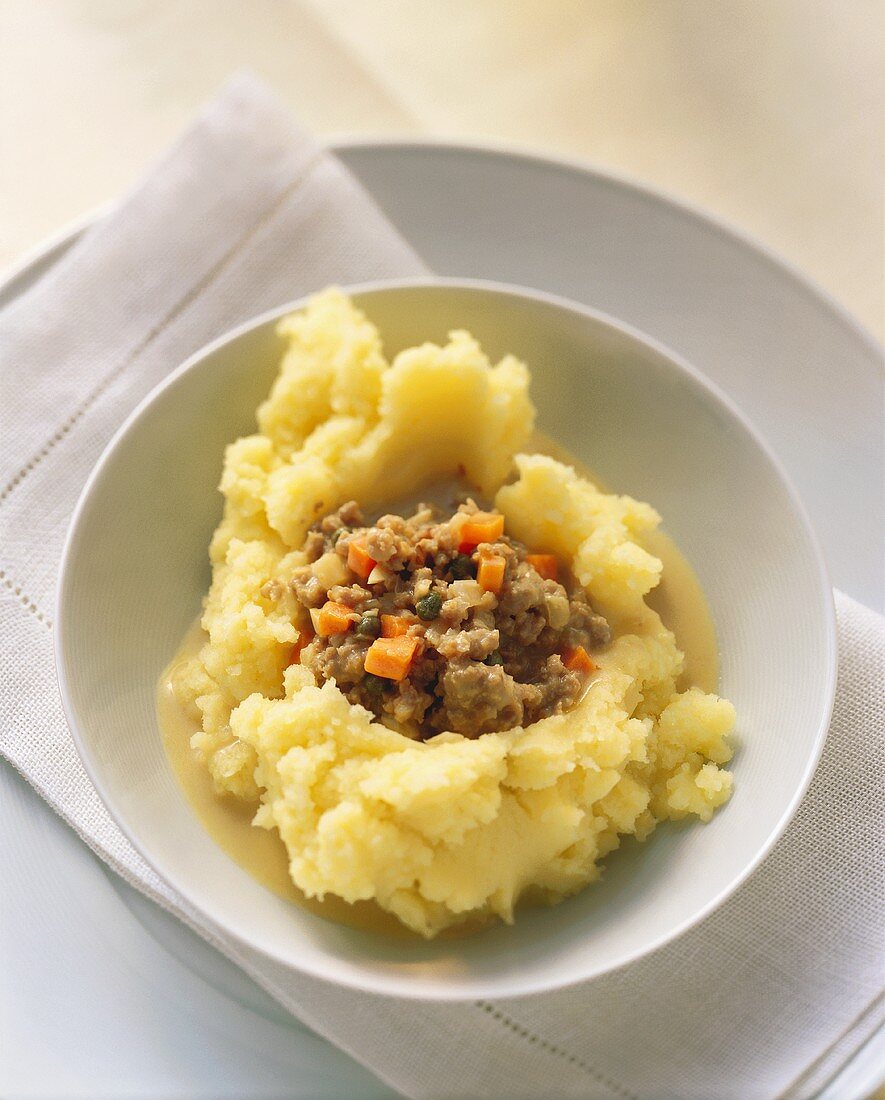 Mashed potato with mince sauce in bowl