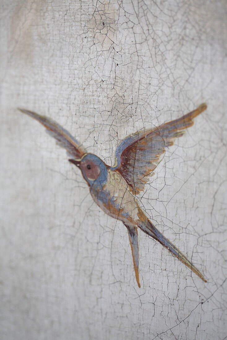 Hand-painted bird in flight on exterior wall, Majorca, Spain