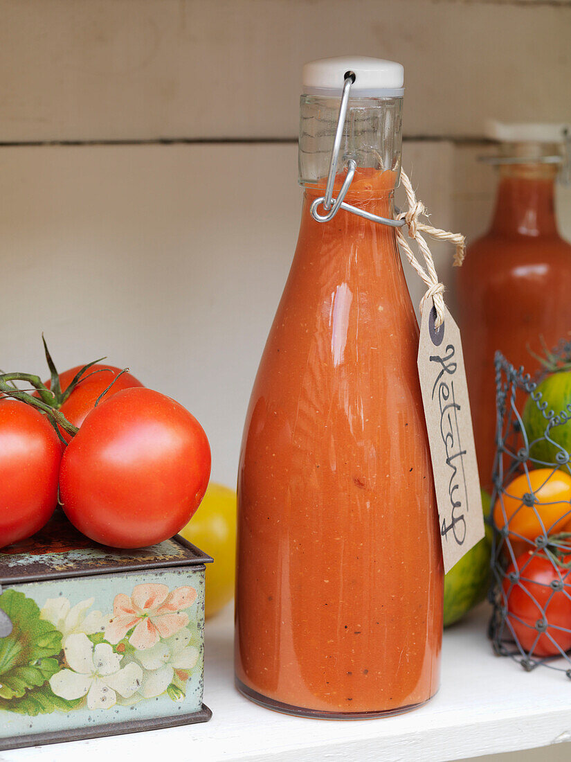 Tomatoes with a bottle of home-made ketchup Battersea London UK