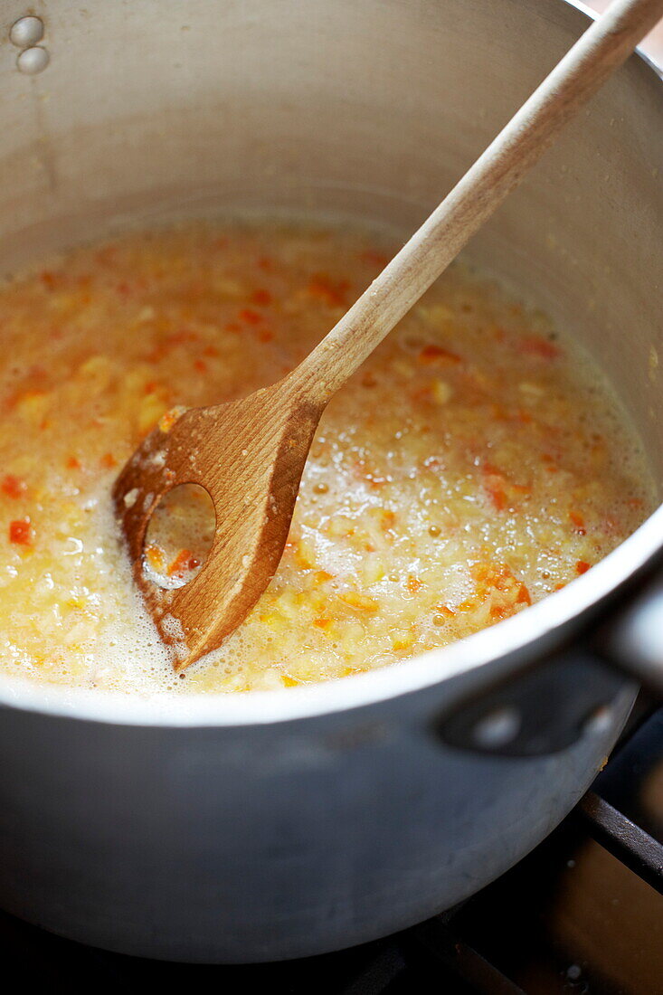 Mixing marmalade in a saucepan, Southend-on-sea, Essex, England, UK