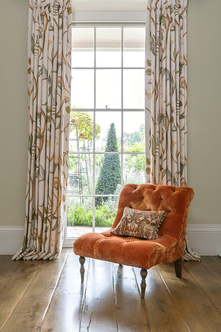 Upholstered velvet chair in window of Georgian Grade II listed Surrey home UK