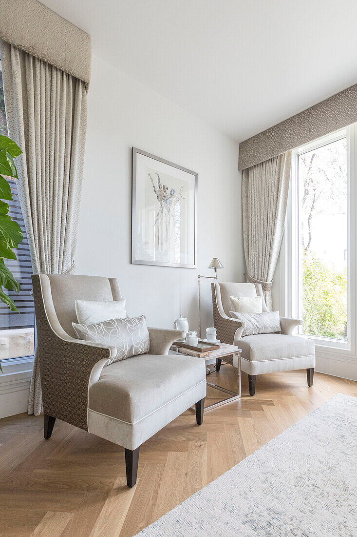 Pair of cream armchairs in sustainable home Highgate London UK