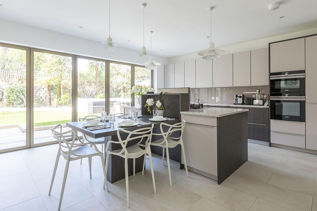 Open plan kitchen with garden view in sustainable newbuild Highgate London UK