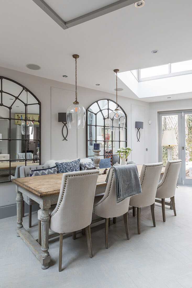 Oak table with metal framed mirrors with glass pendants in semi-detached Victorian terrace Wandsworth London Uk