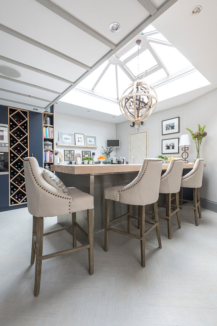 Limed oak breakfast bar with stools below skylight in Victorian terrace Wandsworth London Uk