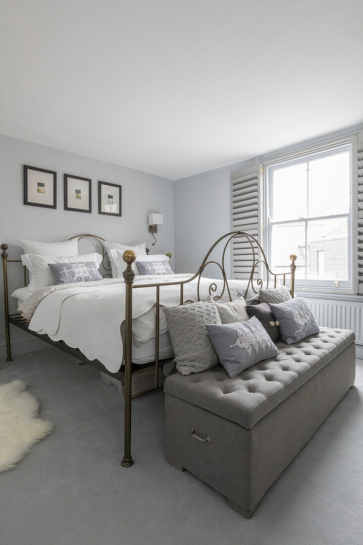 Vintage metal framed bed with buttoned blanket box in Victorian terrace Wandsworth London Uk