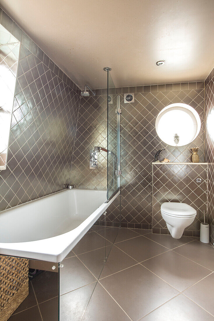 Gold tiled ensuite bathroom in Victorian terrace Wandsworth London Uk