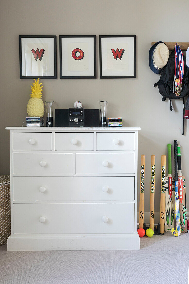 Framed 'wow' above white painted chest of drawers in Grade II listed Jacobean house Alton UK