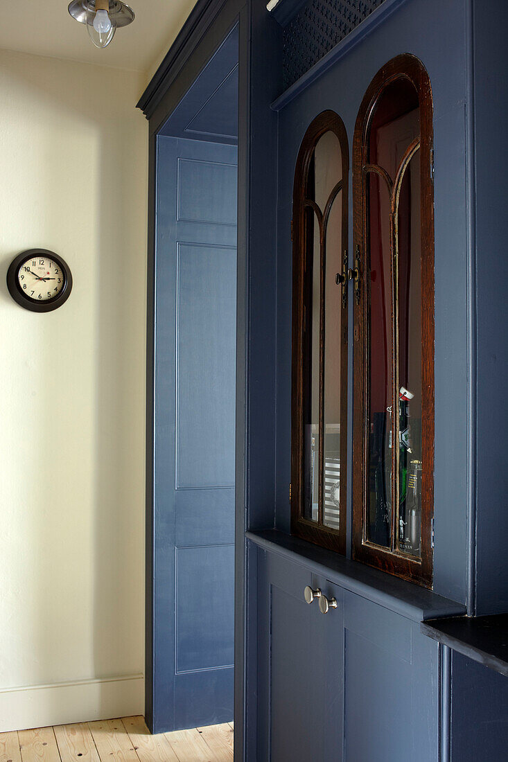 Old wooden glass fronted cabinet in blue side unit, contemporary Bristol home, England, UK