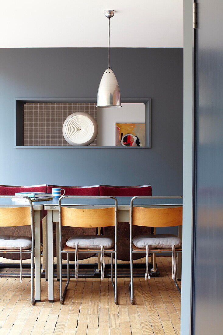 View through doorway to table and pendant light in contemporary new-build Isle of Wight home UK