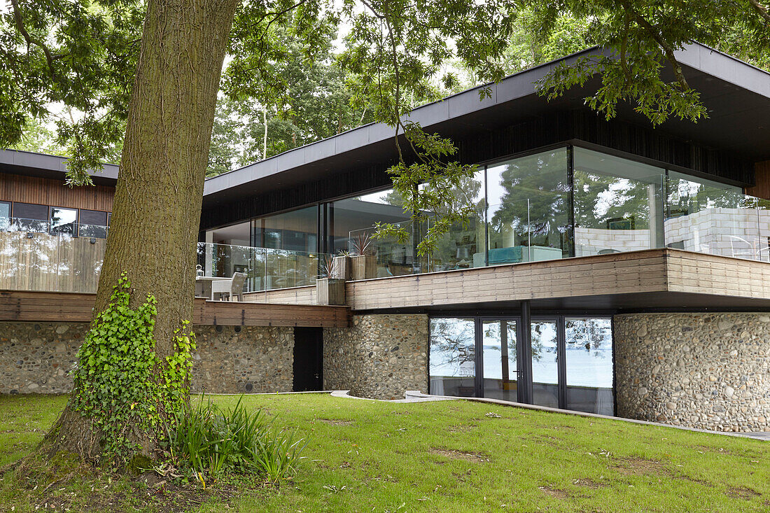 Modern facade of Binstead new-build with timber cladding and pebble-dashed lower storey Isle of Wight, UK