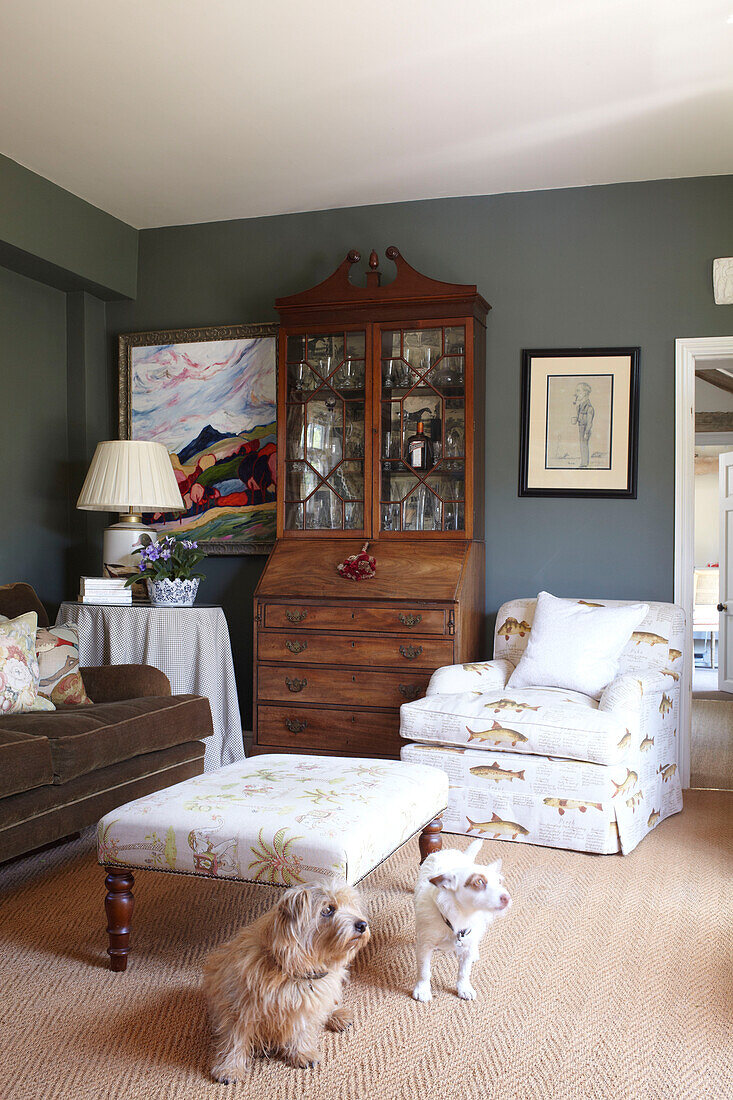 Fish patterned armchair with ottoman footstool in living room of Wiltshire home, England, UK