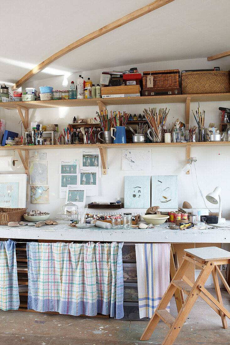 Step ladder and workbench in studio of Bembridge houseboat Isle of Wight, UK