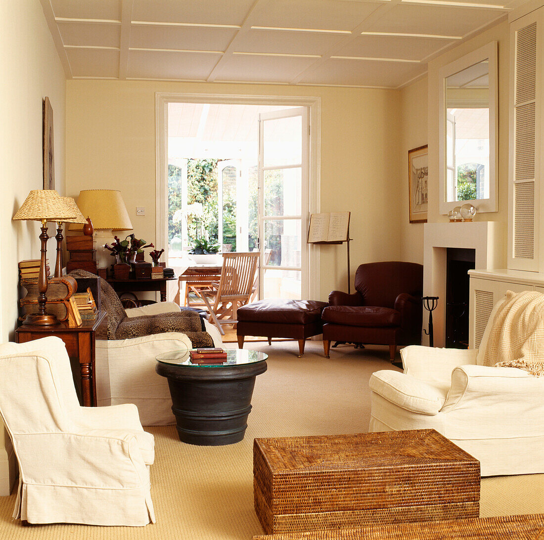 Living room with cream decor and matching furniture and view of conservatory