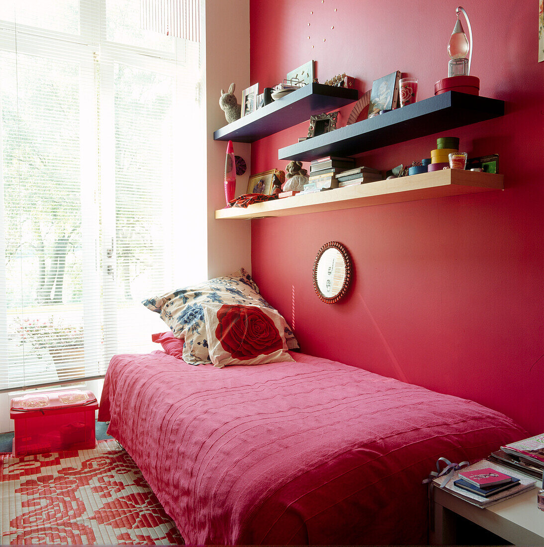 Close up of red single bedroom for teenager with casement window