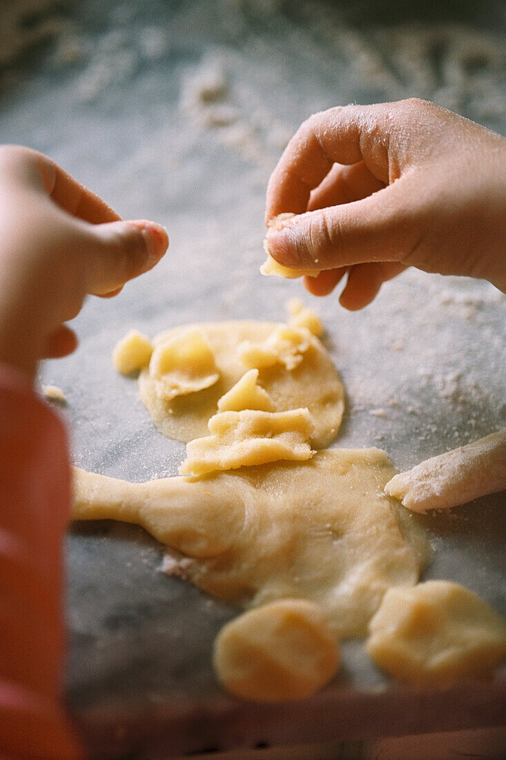 Child making a pastry man