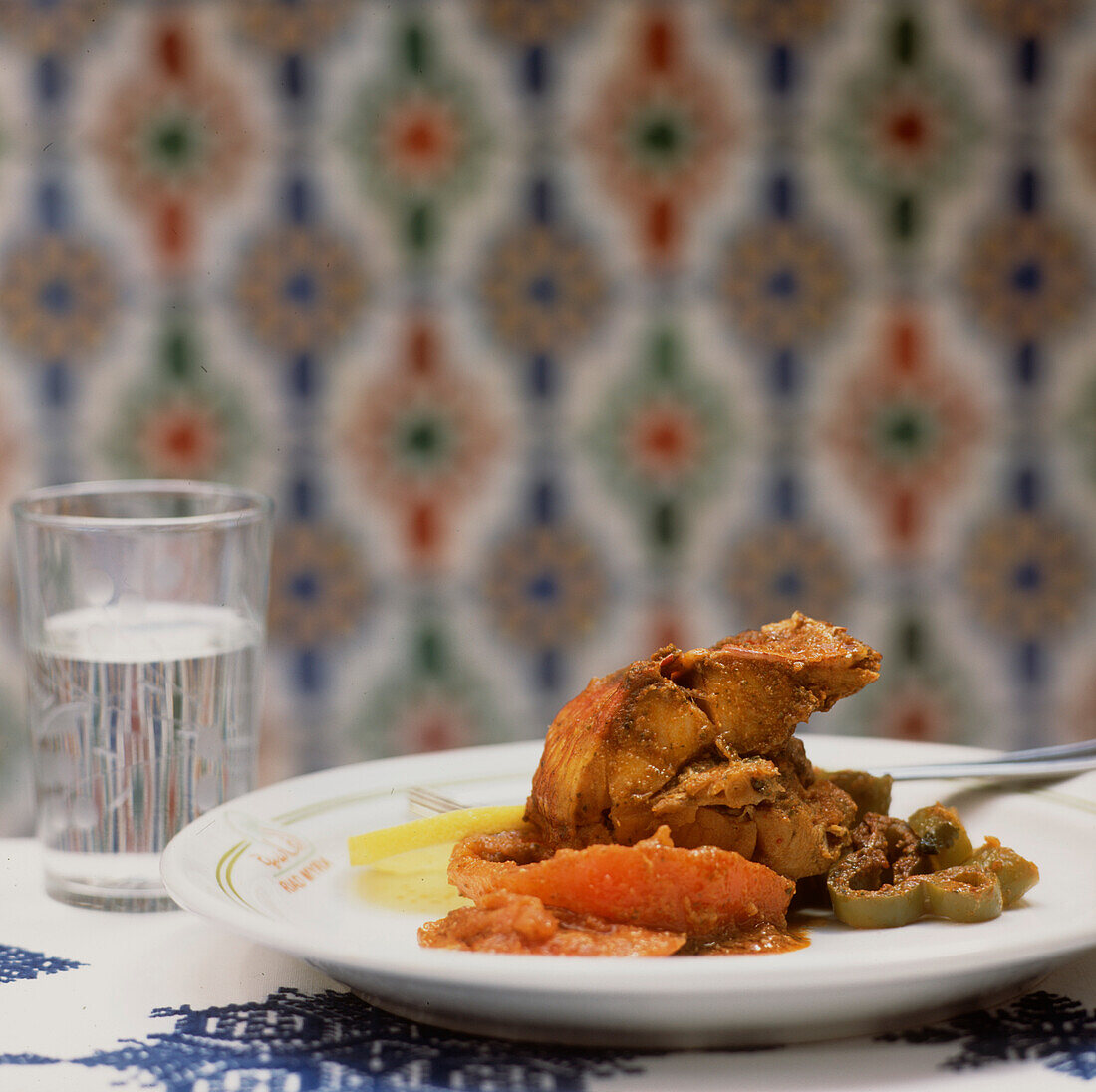 Fish tagine with a herby and spicy charmoula sauce with cooked tomatoes and green peppers