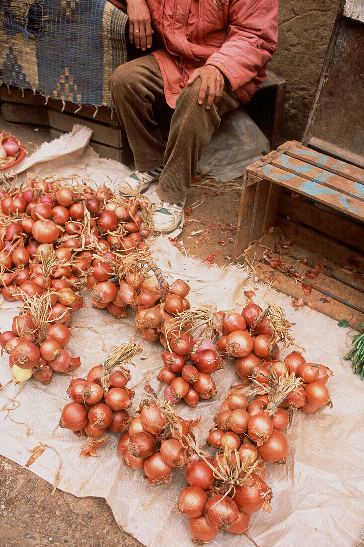 Market stall selling fresh bunches of onions in the medina Fez Morocco