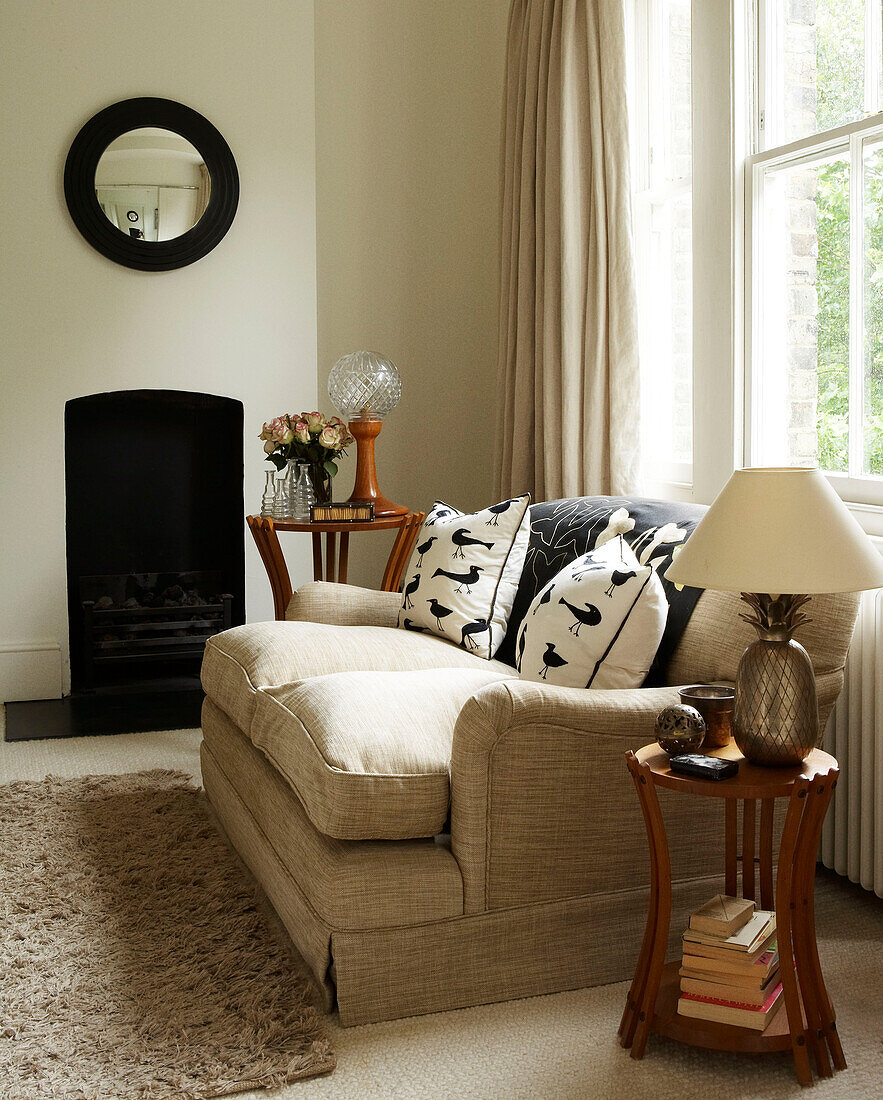 Living room with two seater sofa and fireplace