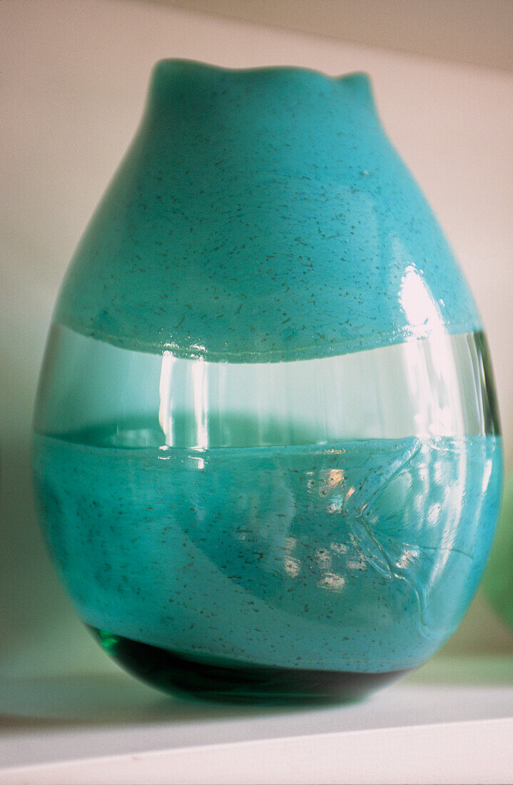 Detail of modern handmade green glass vase