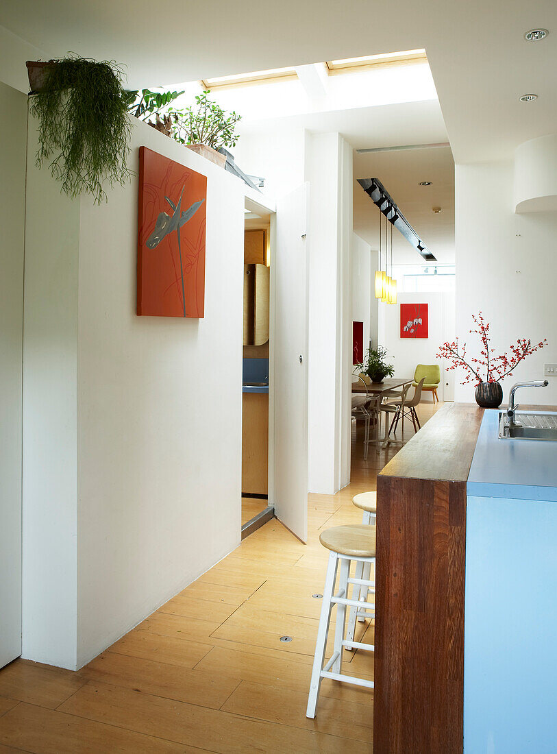 Open plan kitchen with view to dining area and partition wall with skylights