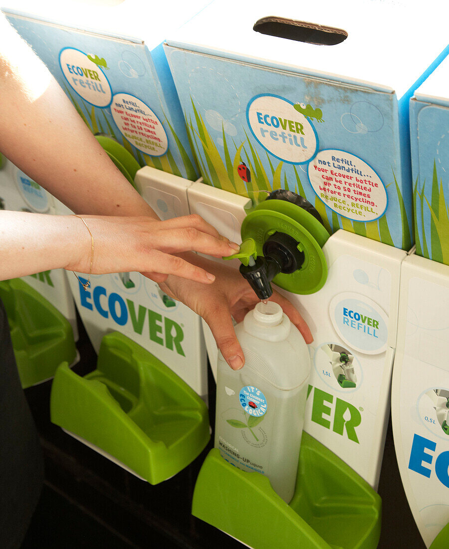 Woman pouring liquid soap from soap dispensers