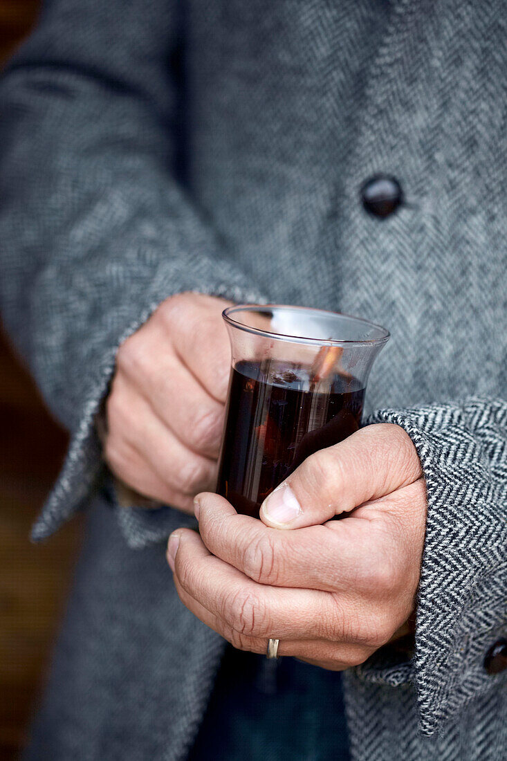 Woman holding mulled wine in Zermatt, Valais, Switzerland