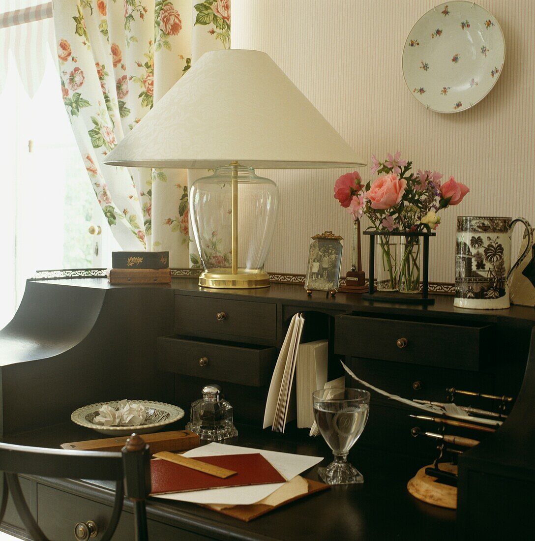 Writing desk detail with flowers and glass of water