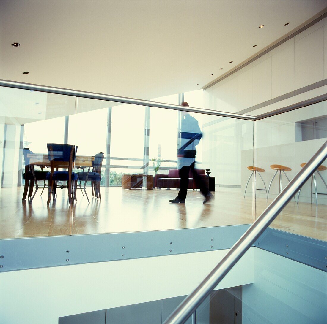 Man walks across laminate floor of open plan contemporary attic