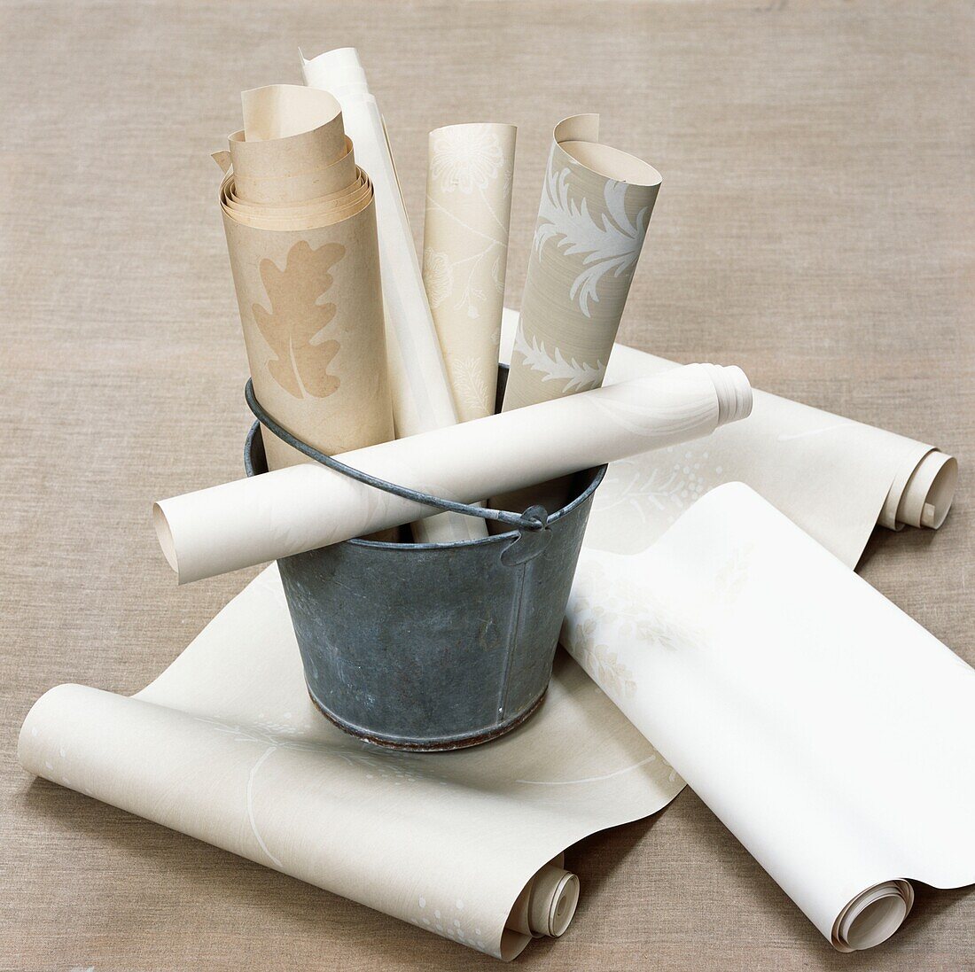 Rolls of wallpaper in a metal bucket