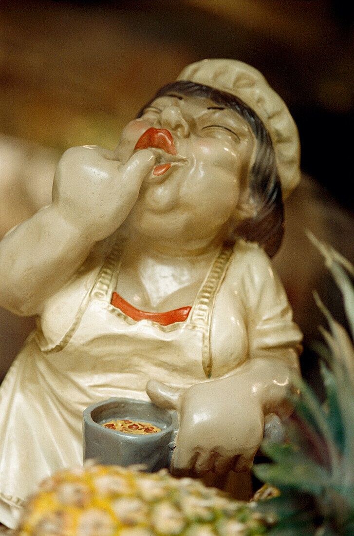 Plaster figurine of cook in a shop window in San Sebastian