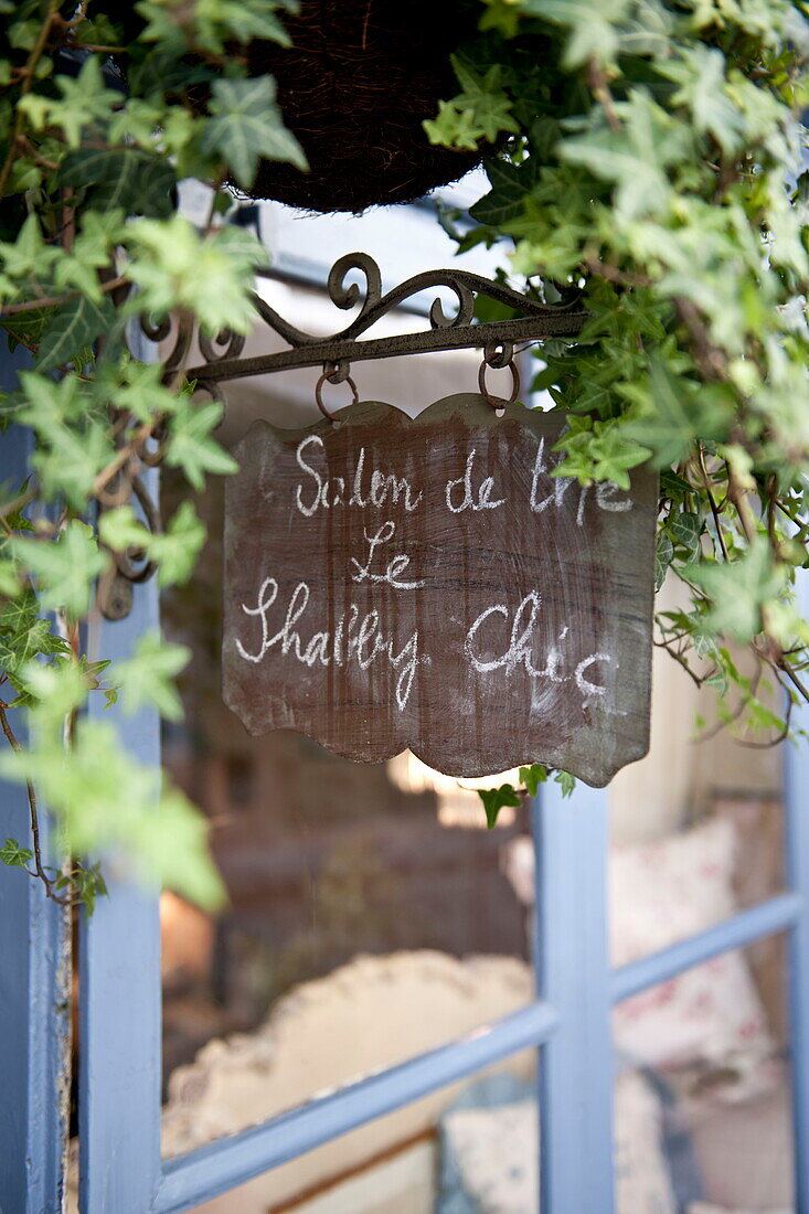 French handwriting on chalkboard at blue gate 'Salon de the',  Dordogne,  France