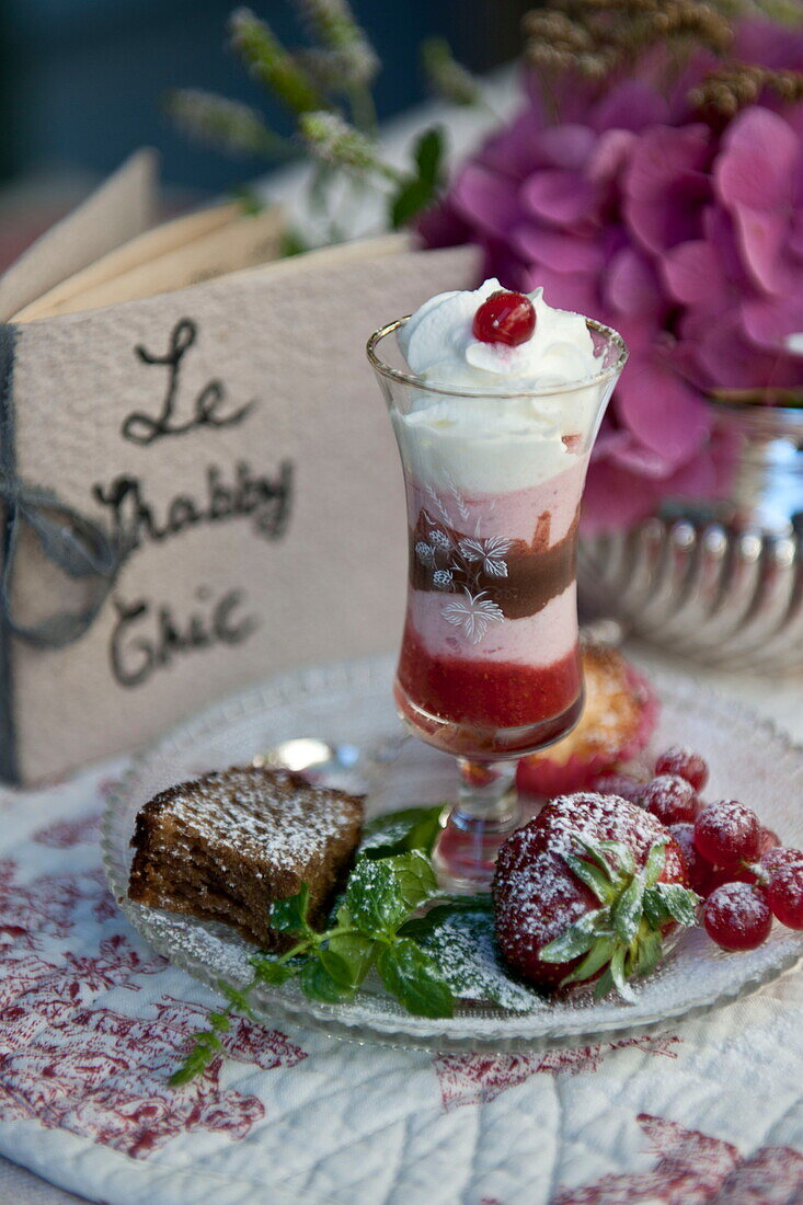 Ice cream sundae with handwritten menu and fruit in tea salon,  Dordogne,  France