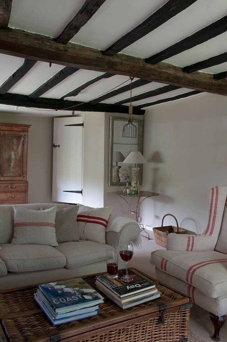 Beamed ceiling with striped fabrics in living room of Kingston home,  East Sussex,  England,  UK