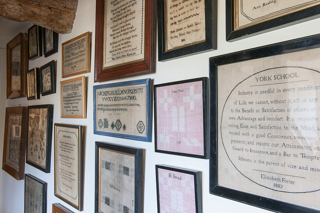 Framed vintage texts on picture wall in Ashford cottage  Kent  UK