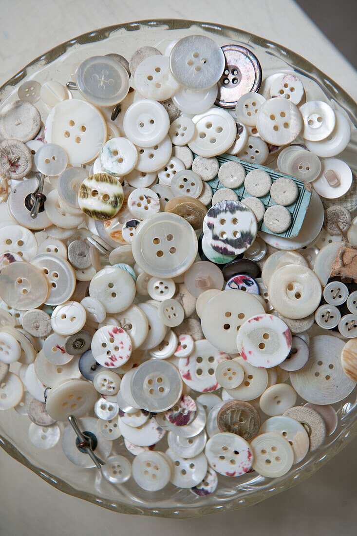 Assorted buttons on glass cake stand in Kent home  England  UK