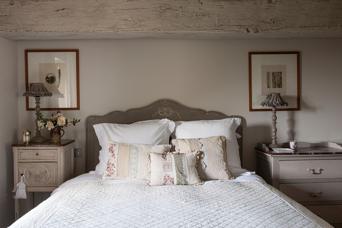 Handmade cushions on double bed in beamed Dordogne farmhouse  Perigueux  France