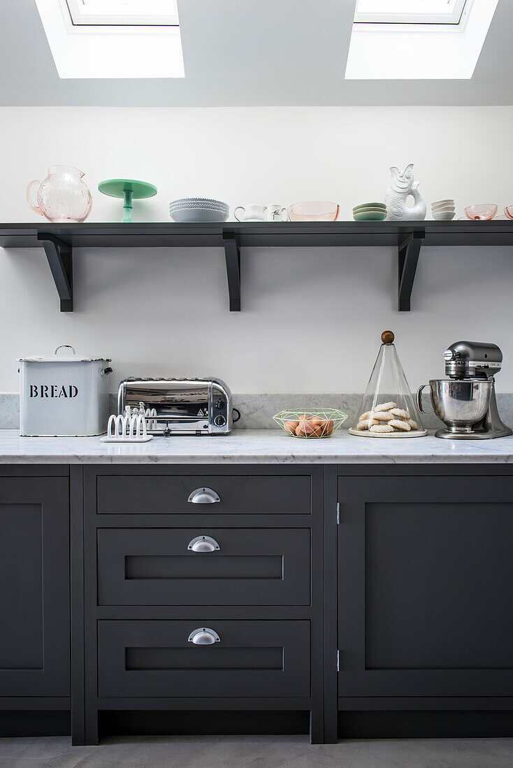 Food mixer and breadbin with toaster under skylight windows in Whitstable kitchen   Kent  England  UK